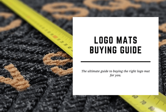 A logo mat is shown close up with a measuring tape over it. The blog header reads Logo Mats Buying Guide.