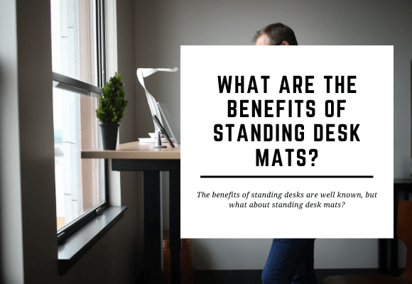 A man is working at a standing desk. The blog header reads What are the Benefits of a Standing Desk Mat?