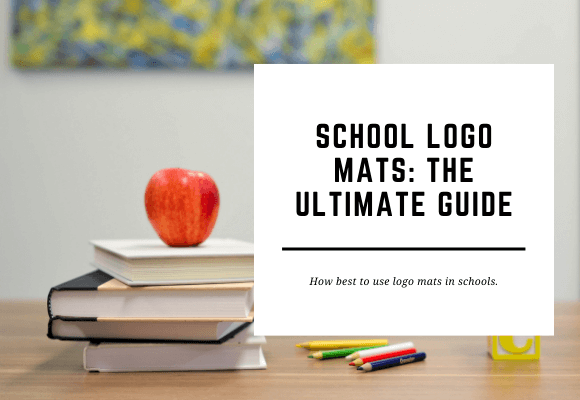 An apple sits on top of a stack of books with other schools supplies surrounding. The blog header reads School Logo Mats: The Ultimate Guide.