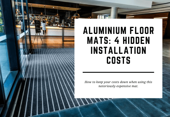 An aluminium floor mat sits in the entrance to a bar. The blog header reads Aluminium Floor Mats: 4 Hidden Installation Costs.