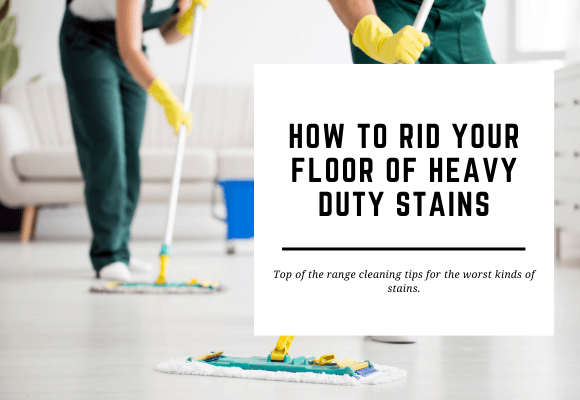 2 cleaners are mopping a hard shiny floor. The blog header reads How to Rid Your Floor of Heavy Stains.