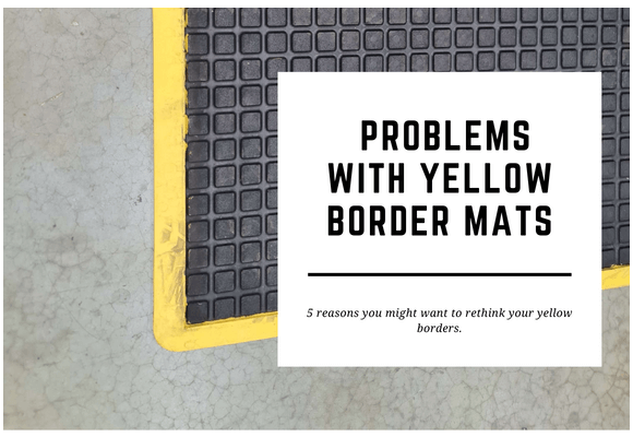 A black anti fatigue mat with a yellow border is laid on a factory floor. The blog header reads Problems with Yellow Border Mats.