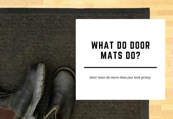 A pair of shoes lay on a black door mat on a wooden floor. The blog header reads What Do Door Mats Do?
