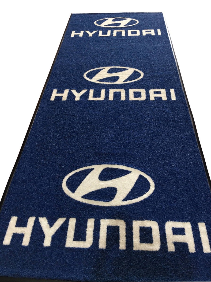 An entrance mat with Hyundai branding is shown alone. It is blue with white print.