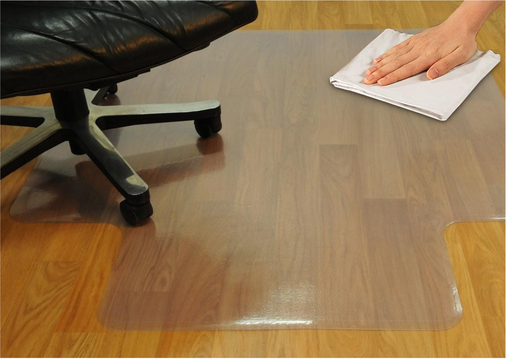 A hand wipes a chair mat to demonstrate its easy maintenance.