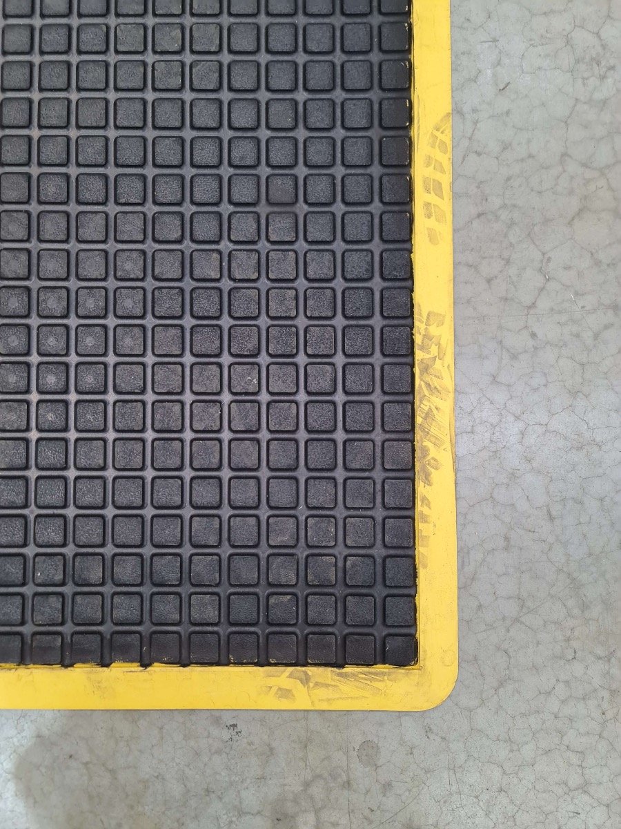 Yellow border coming away from black mat.