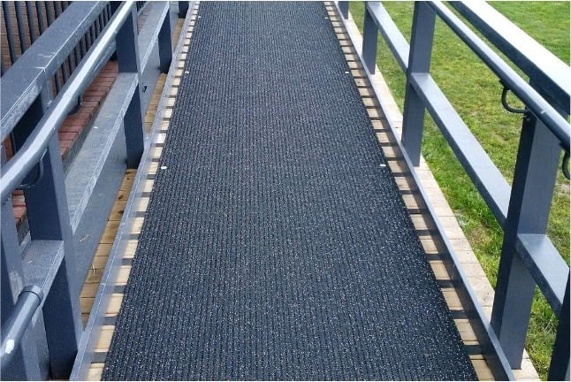 A rubber mat lines a ramp.